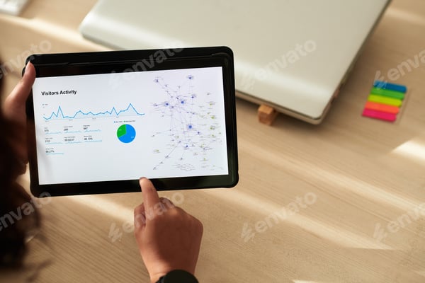An analyst reviewing a report on a tablet
