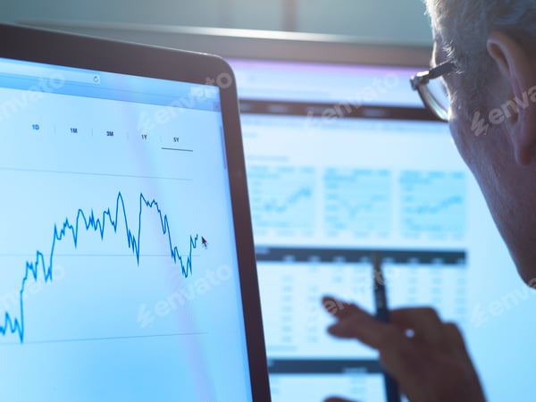 An analyst researching financial data at a desk