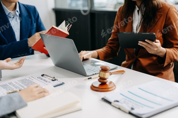 People reviewing contract documents at a table